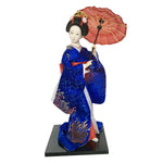 poupée japonaise geisha argile broderie florale motifs géométriques accessoires traditionnels blanc rouge vert bleu