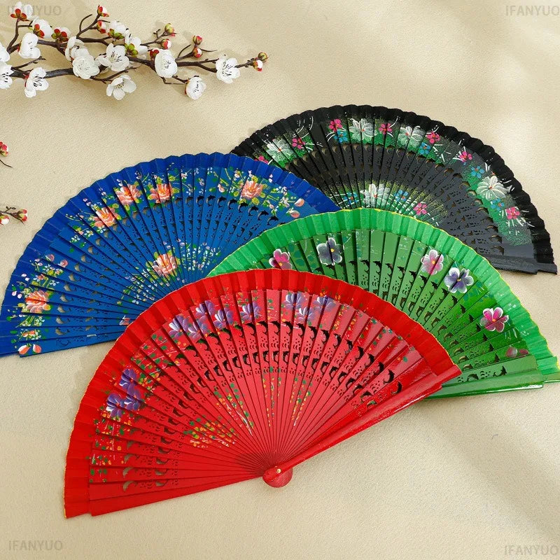 éventail pliant fleurs colorées bois multicolore traditionnel perforations rouge vert bleu élégant