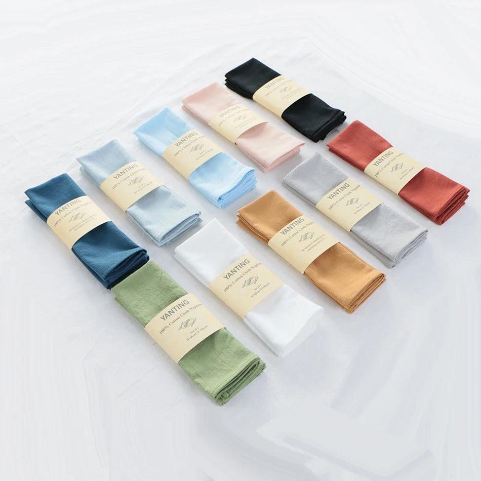 Une collection de carrés de tissu de diverses couleurs, y compris le bleu, le rose, le vert et le doré, emballés individuellement et portant l'étiquette "Vantting".