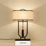lampe table tissu texturé moderne asiatique pompon abatjour opaque métal noir