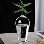 vases verre transparent modernes élégants branches feuilles roses arrangements floraux table maison mariage