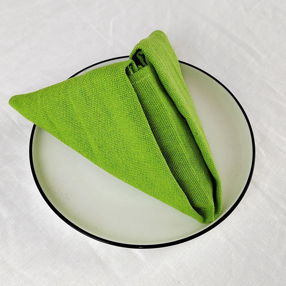Un torchon vert vif posé sur un miroir en verre rond noir.