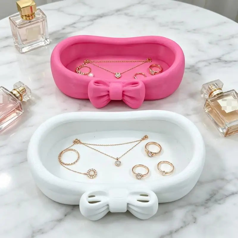 rangement bijoux rose blanc nœud papillon doux féminin surface lisse mat organisateur coiffeuse cosmétiques