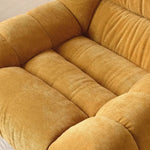fauteuil pivotant moderne rose velours côtelé intérieur coussin décoratif livres vase fleurs