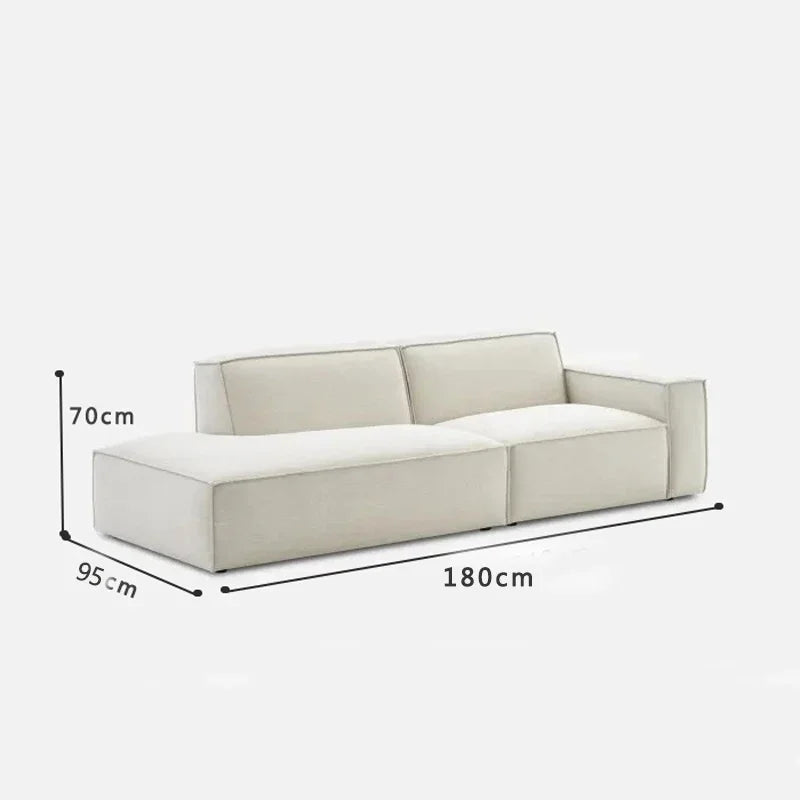 canapé d'angle moderne beige clair uni confortable salon minimaliste inclusion coussins tapis