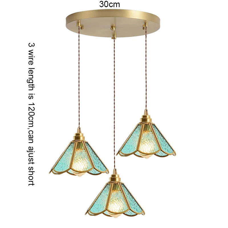 suspension lumineuse verre teinté art deco or marron bleu clair motifs géométriques opacité chaînes