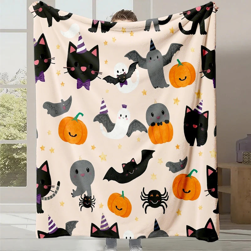 Une couverture festive avec des motifs d'Halloween amusants, comme des chats noirs, des chauves-souris, des citrouilles et des étoiles.