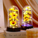 décoration florale cloche verre fleurs jaunes tige verte base noire guirlande led lumineuse romantique