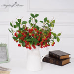 Branche de baies de Noël artificielles noires dans un vase de table