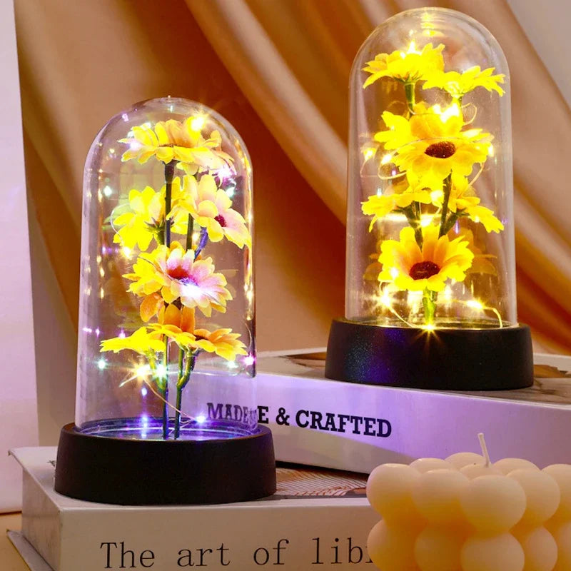 décoration florale cloche verre fleurs jaunes tige verte base noire guirlande led lumineuse romantique
