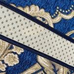 Motif floral abstrait en tons de bleu et de doré avec des points sur un fond texturé.