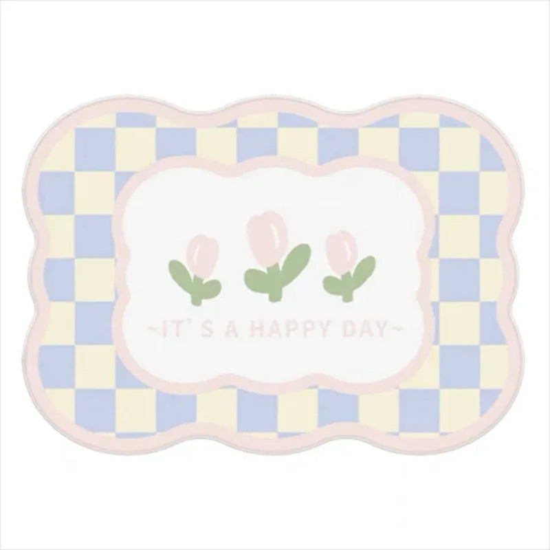Tapis doux et coloré avec des motifs abstraits en forme de carrés, orné de fleurs vertes et portant l'inscription "It's a happy day".