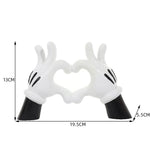 support bijoux main stylisée coeurs blancs résine noire moderne anneaux dorés decoration house