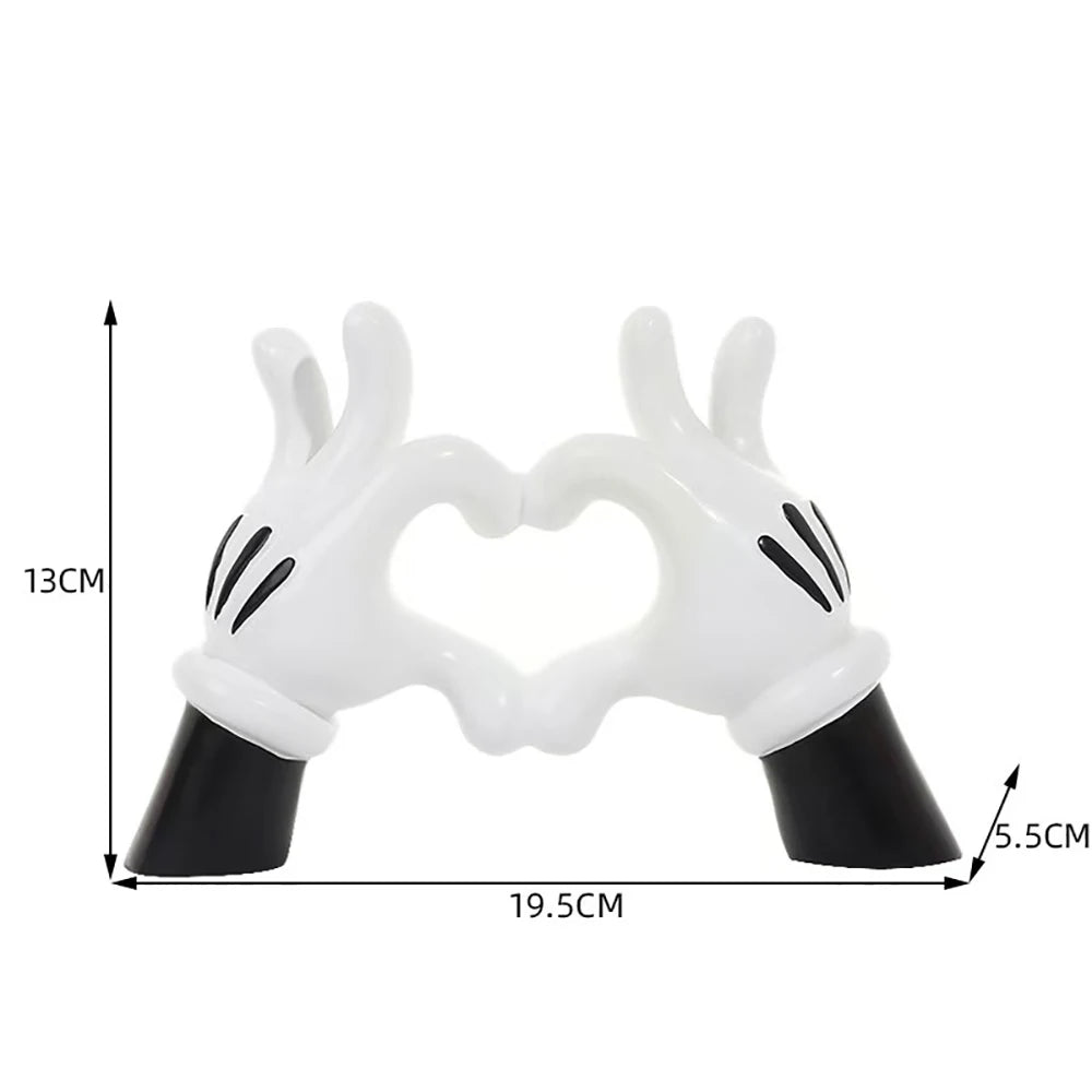support bijoux main stylisée coeurs blancs résine noire moderne anneaux dorés decoration house