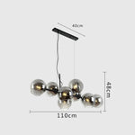 Suspension lumineuse moderne sphères transparentes dorées structure métallique noir chambre salon