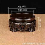 support circulaire bois sculpté artisanal traditionnel marron foncé détails complexes vase plantes décoration maison