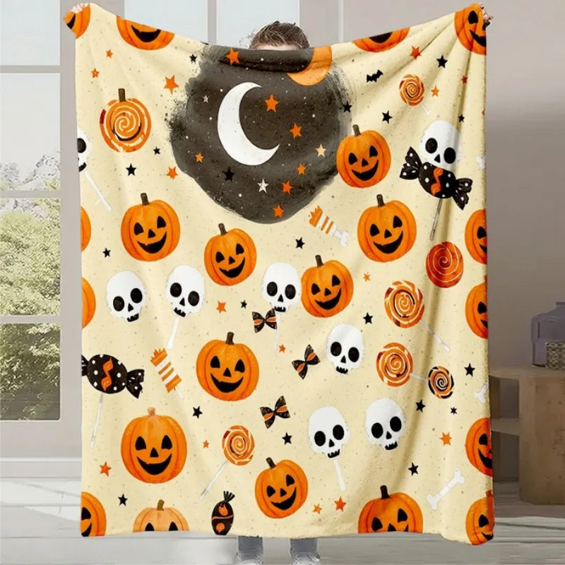 Couverture réversible de Halloween avec citrouilles, crânes et lunes sur un fond blanc avec des étoiles.