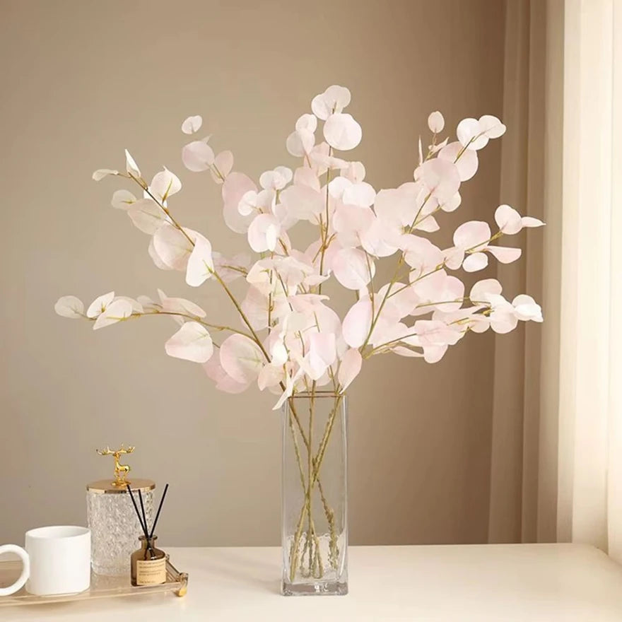bouquet artificiel feuilles ovales moderne vase transparent support doré couleurs vives exposition intérieure