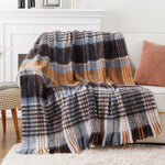 Une couverture en laine à carreaux gris, orange et blancs, parfaite pour une décoration cosy et confortable.