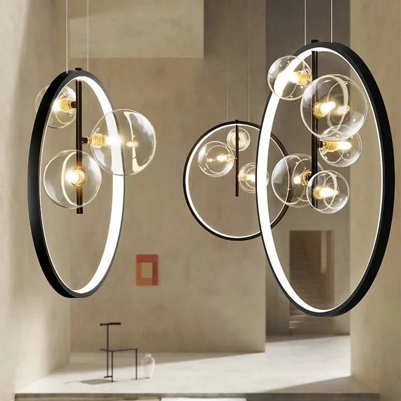 lumière suspendue moderne pendentif géométrique transparent cercles métalliques dorés chambre salon