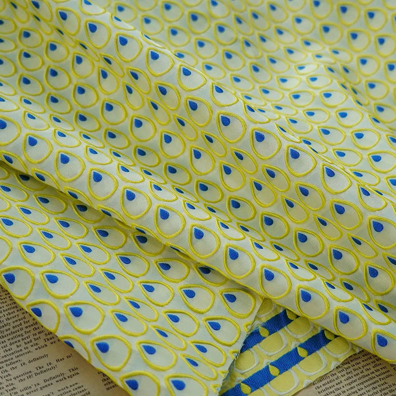tissu polyester jaune bleu motif gouttes plumes decoratif moderne largeur 150cm graphique Jacquard