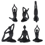 ornements deco moderne figurines yoga noires differentes poses minimaliste sculptural