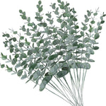 bouquet artificiel feuilles vertes naturel minimaliste ruban blanc vase blanc tapis beige ornement extérieur