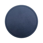 Tapis de souris rond en cuir bleu marine avec bordure en couture.