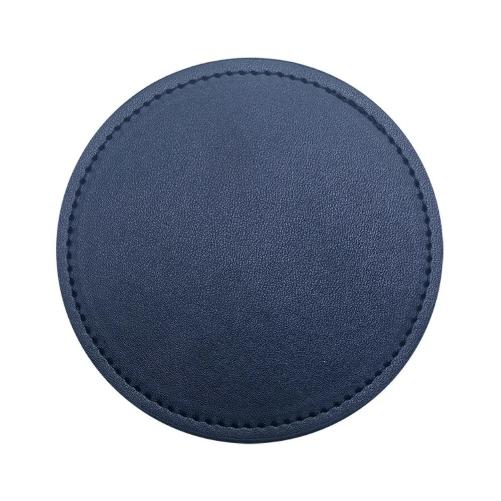 Tapis de souris rond en cuir bleu marine avec bordure en couture.