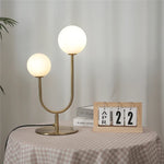 lampe table moderne or blanc sphères translucides câble noir base plate