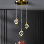 lampe suspendue or transparent cristal facettes géométriques moderne élégante tringles câbles