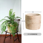 Pot plante tissé marron clair moderne rustique plante verte graines noires serviette blanche