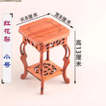 table basse bois rose classique gravures artisanal marron clair pot plante figurine cadre photo