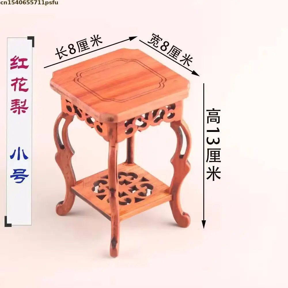 table basse bois rose classique gravures artisanal marron clair pot plante figurine cadre photo