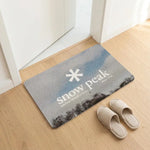 tapis sol noir logo snow peak minimaliste antidérapant bain moderne camping usage