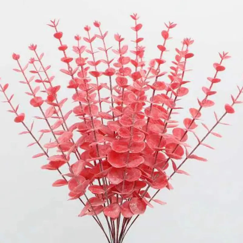 bouquet artificiel feuilles vertes naturel minimaliste ruban blanc vase blanc tapis beige ornement extérieur