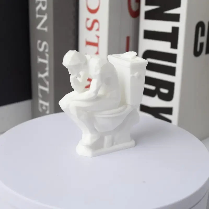 statue humoristique penseur assis toilettes blanc artistique parodie