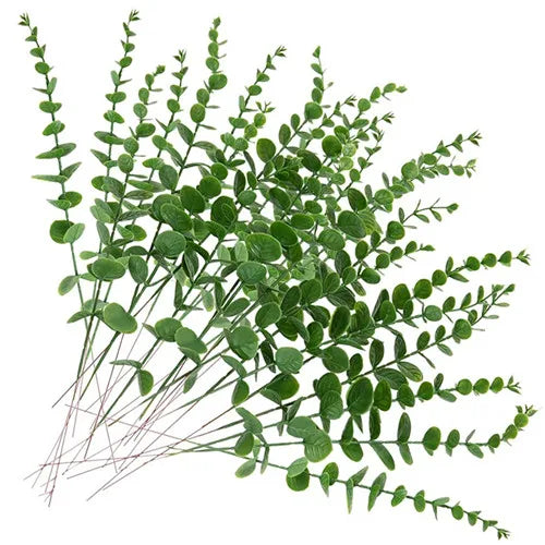 bouquet artificiel feuilles vertes naturel minimaliste ruban blanc vase blanc tapis beige ornement extérieur