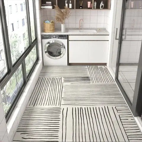 L'image montre une cuisine élégante et épurée avec un lave-linge, des étagères, et un sol carrelé aux motifs géométriques en noir et blanc.