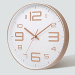 horloge murale moderne chiffres relief aiguilles fines blanc rose doré noir minimaliste