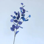 bouquet artificiel feuilles ovales moderne vase transparent support doré couleurs vives exposition intérieure
