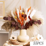 bouquet fleurs séchées boho beige orange brunes plumes feuilles naturel vase blanc plateau bois