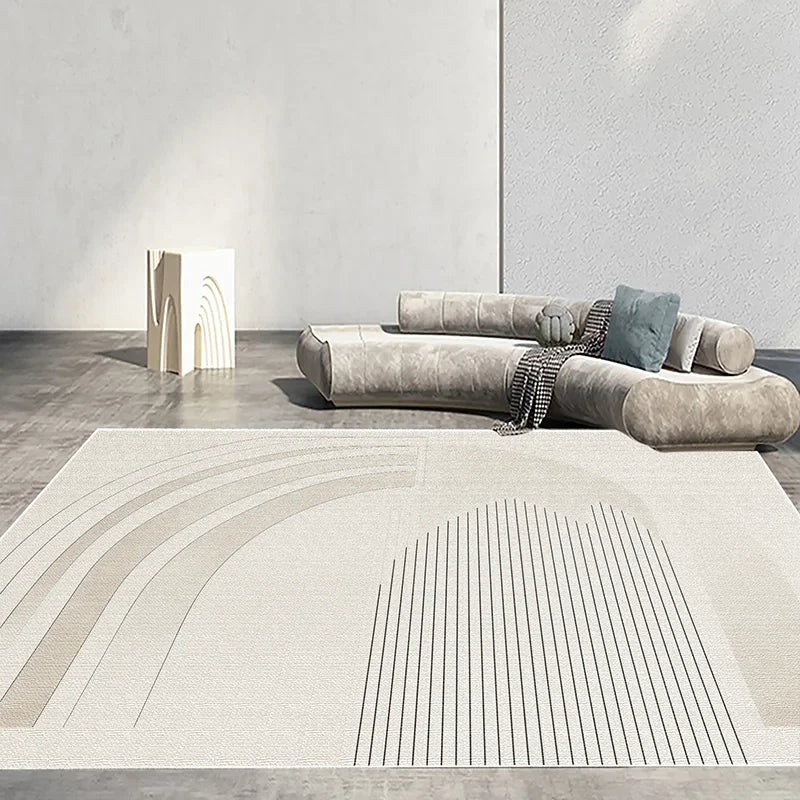 Cette image montre un espace moderne et minimaliste, avec un canapé gris et des formes géométriques sur le sol, créant une ambiance élégante et épurée.