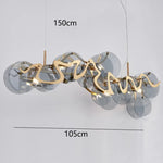 suspension lumineuse moderne transparente dorée ronds ondulés élégante chaînes suspendues ampoules métal