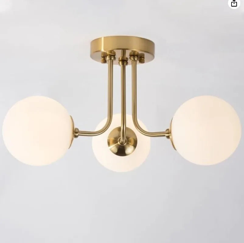 luminaire moderne or noir globes verre opaques semi suspendus métal
