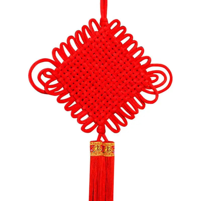 guirlande traditionnelle chinoise tissée artisanale rouge motifs géométriques pompon ruban doré festive printemps