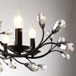 chandelier noir moderne cristaux transparents ampoules blanc chaud suspension élégante branches floralesstylisées