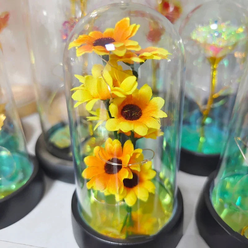 décoration florale cloche verre fleurs jaunes tige verte base noire guirlande led lumineuse romantique