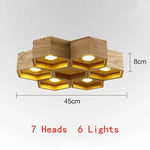 lumière suspendue bois clair nid d'abeille hexagonal modernes led câbles argentés structure géométrique