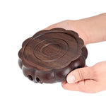 support décoration bois marron foncé texture naturelle gravure circulaire classique artisanal théière vase boule